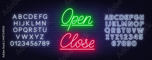Neon sign open and close on brick wall background.