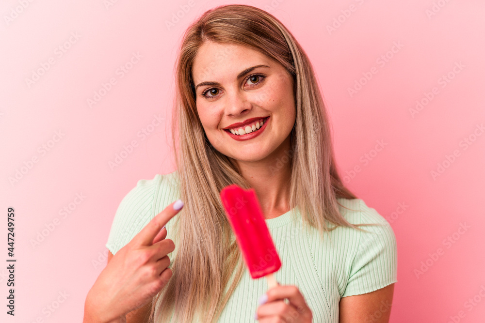 Young russian woman holding an ice cream isolated on pink background Young russian woman holding an ice cream isolated on pink background