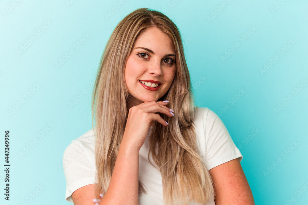 Young russian woman isolated on blue background Young russian woman isolated on blue background