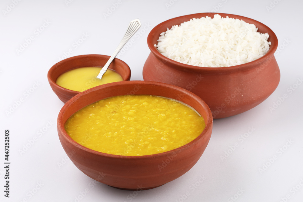 Indian staple food everyday meal Dal Rice or yellow lentil soup with white rice and ghee also called dal chaval & varan bhat Indian staple food everyday meal Dal Rice or yellow lentil soup with white rice and ghee also called dal chaval & varan bhat