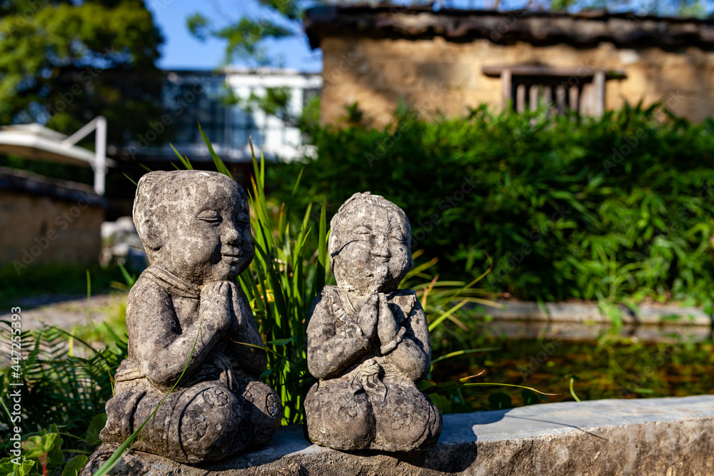 Two stone sculptures near the pool Two stone sculptures near the pool
