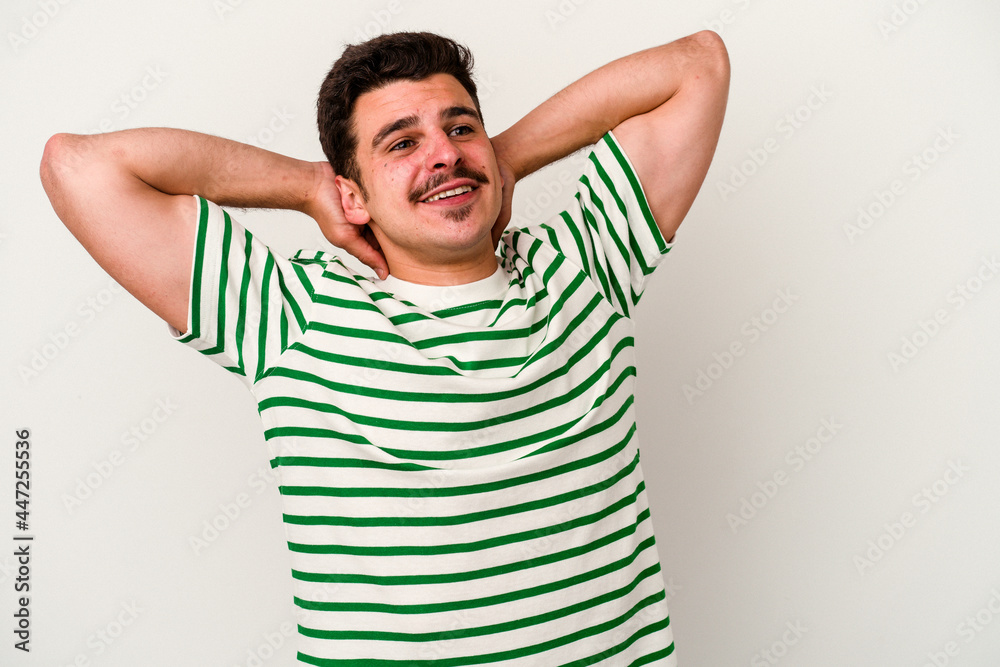 Young caucasian man isolated on white background feeling confident, with hands behind the head. Young caucasian man isolated on white background feeling confident, with hands behind the head.