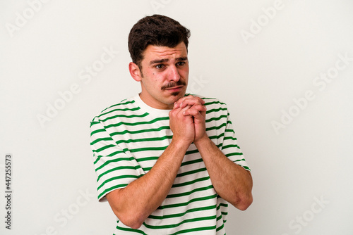 Young caucasian man isolated on white background scared and afraid.