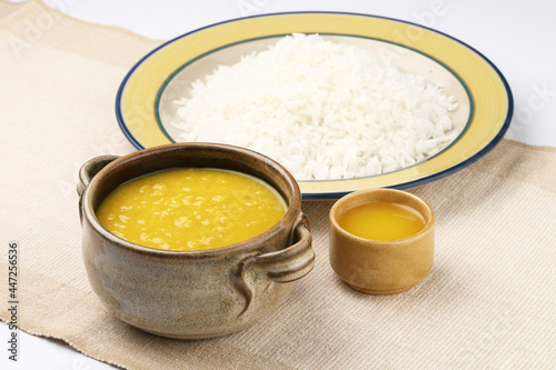 Indian staple food everyday meal Dal Rice or yellow lentil soup with white rice and ghee also called dal chaval & varan bhat photo