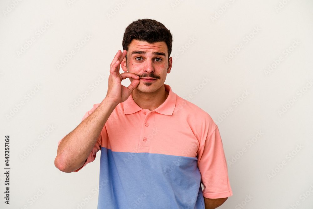 Young caucasian man isolated on white background with fingers on lips keeping a secret. Young caucasian man isolated on white background with fingers on lips keeping a secret.