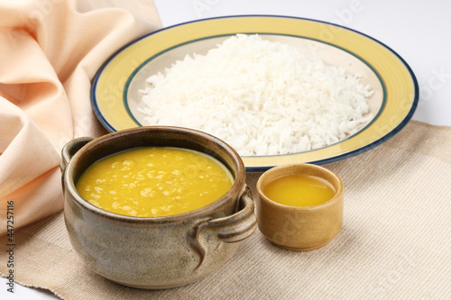 Indian staple food everyday meal Dal Rice or yellow lentil soup with white rice and ghee also called dal chaval & varan bhat