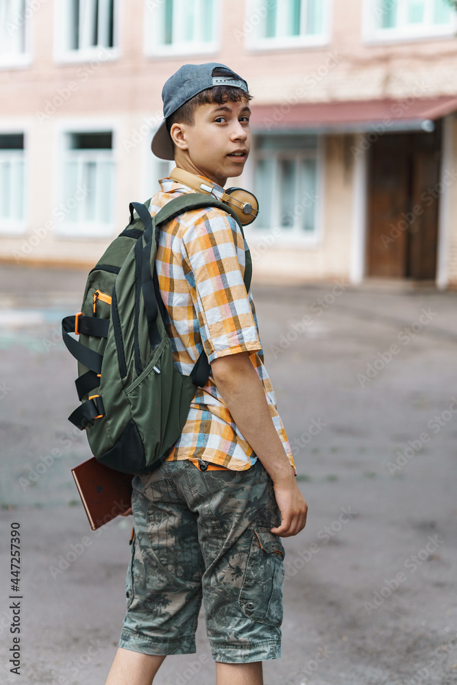 teen boy portrait on the way to school, education and back to school concept