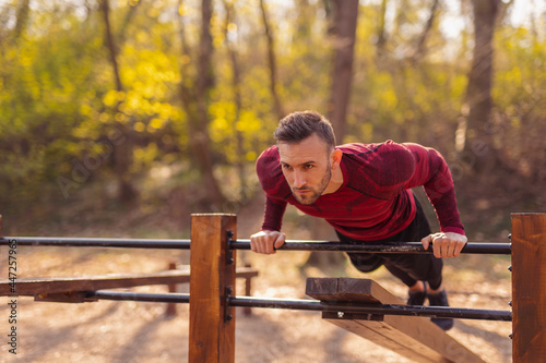 Man working out outdoors, doing push ups
