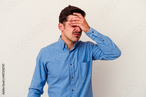 Young caucasian man isolated on white background touching temples and having headache.