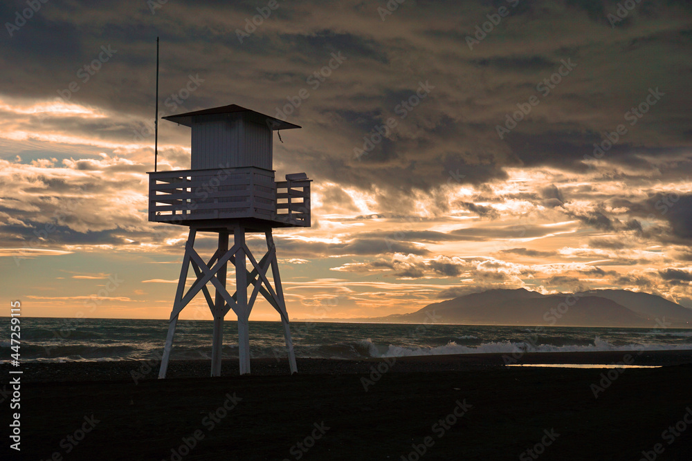 Beach tower with grey sky and rough sea Beach tower with grey sky and rough sea
