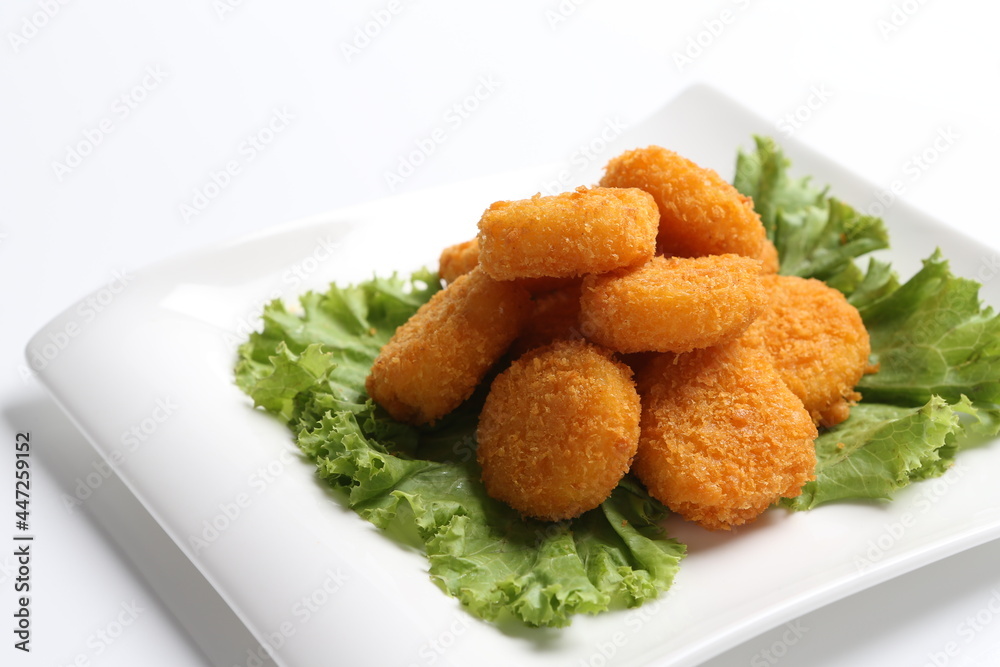 deep fried crispy golden scallops or chicken or fish nugget salad in white black background dim sum snack halal menu deep fried crispy golden scallops or chicken or fish nugget salad in white black background dim sum snack halal menu