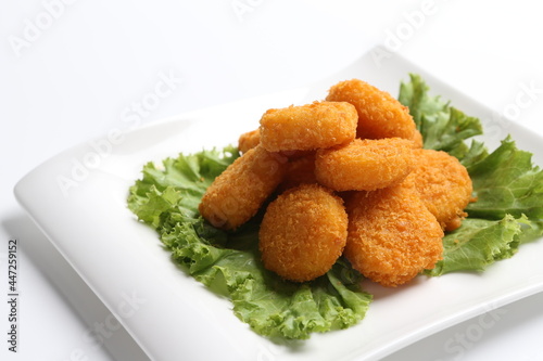 deep fried crispy golden scallops or chicken or fish nugget salad in white black  background dim sum snack halal menu
