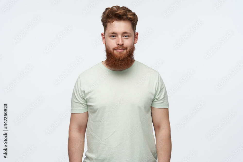 young confident redhead male, watching at the camera, smiling while posing in studio. isolated over white background. young confident redhead male, watching at the camera, smiling while posing in studio. isolated over white background.