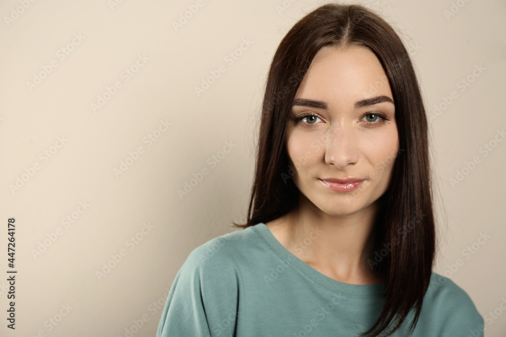 Portrait of pretty young woman with gorgeous chestnut hair on light background, space for text