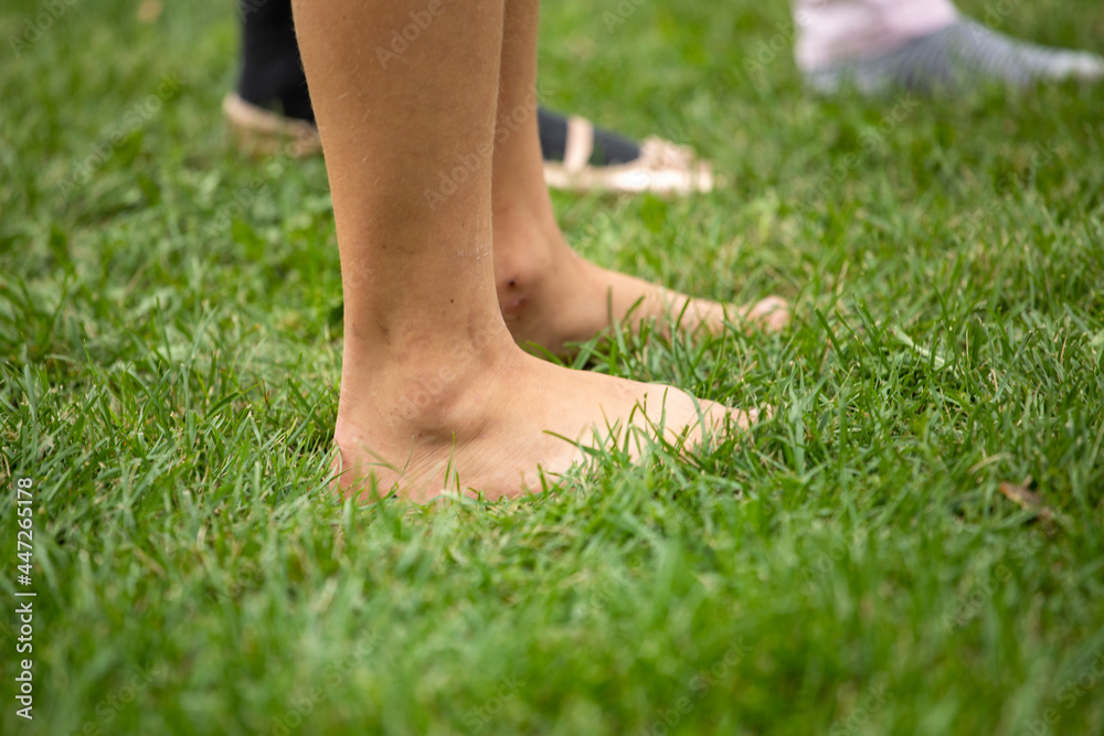 early morning walking barefoot on the grass, good morning, horizontal.