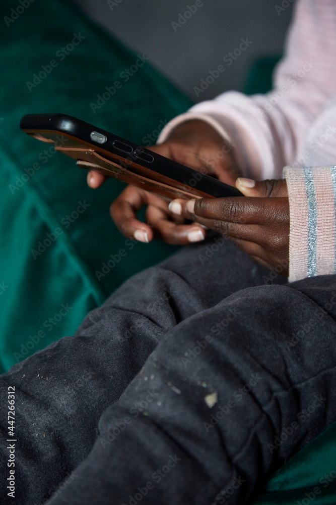 Young black girl's hands using a phone Young black girl's hands using a phone