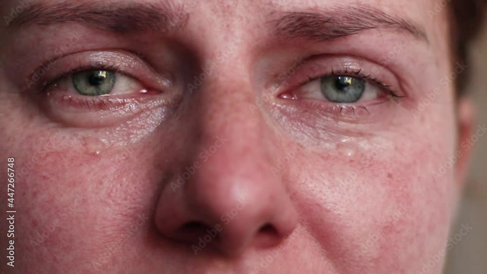Close-up macro shot with zoom of Caucasian crying eyes. Tears are flowing. Close-up macro shot with zoom of Caucasian crying eyes. Tears are flowing.