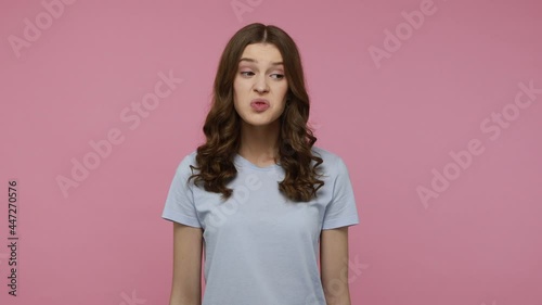 Unpleasant odor. Teenager lady with dark wavy hair pleasure and pinching nose, gesturing go away with your stinking breath, disgusting smell. Indoor studio shot isolated over pink background. photo