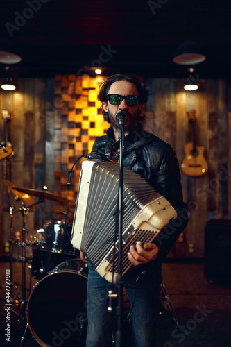 Brutal musician with accordion, music performing
