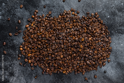 Roasted coffee beans on rustic table. Black background. Top view © Vladimir