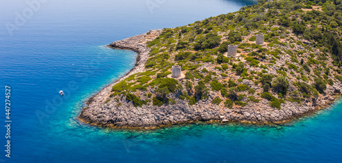 Canvas-taulu Aerial view of antiquated stone windmills at a cape in Ithaca in Ithaca near the