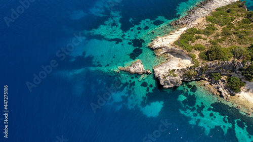 Top down aerial shot of rocks in the turquoise sea of Gidaki beach in Ithaca, Greece © Haris Photography
