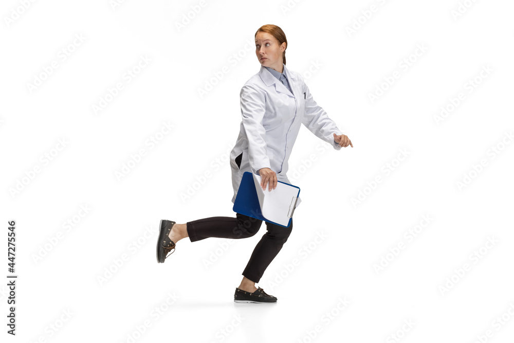 Portrait of running doctor, therapeutic or medical advisor in action and motion isolated on white background. Concept of healthcare, care, medicine