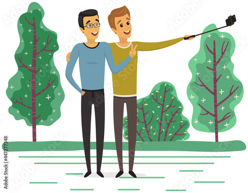 Male friends taking selfie with smartphone. People spend time and make photo together. Friendship and technology concept. Men with phone on monopod are posing for joint photo on background of forest