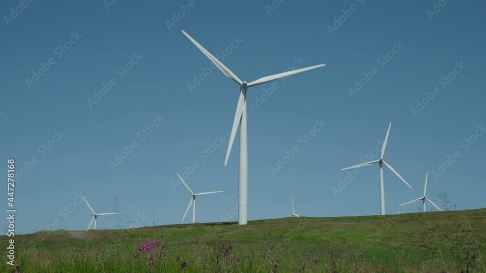 Wind Farm Turbines turning against blue sky Wind Farm Turbines turning against blue sky