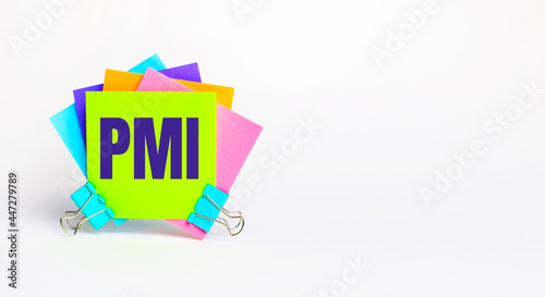 There are bright multi-colored stickers with the text PMI Project Management Institute on a white background. Copy space photo