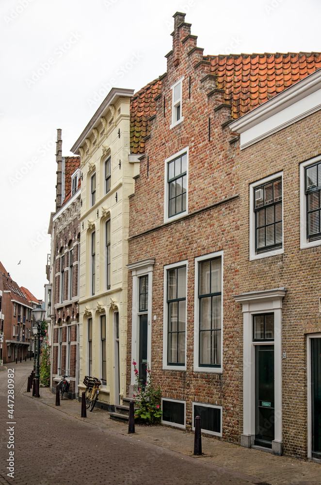 Vlissingen, The Netherlands, July 24, 2021: curving street in the old town lined with traditional facades in brick and plaster