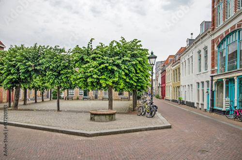 Vlissingen, The Netherlands, July 24, 2021: tree-lined little square and street with colorful facades in the old town