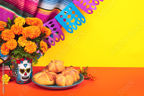 Day of the dead, Dia De Los Muertos Celebration Background With Skull, calaverita vase, marigolds or cempasuchil flowers, bread of death or Pan de Muerto with Copy Space. Traditional Mexican culture  photo