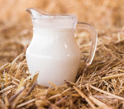 fresh milk in a jug in the hayloft