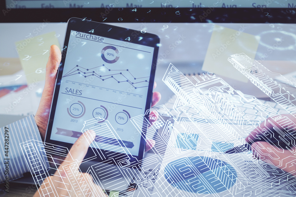 Double exposure of man's hands holding and using a digital device and city drawing. Double exposure of man's hands holding and using a digital device and city drawing.