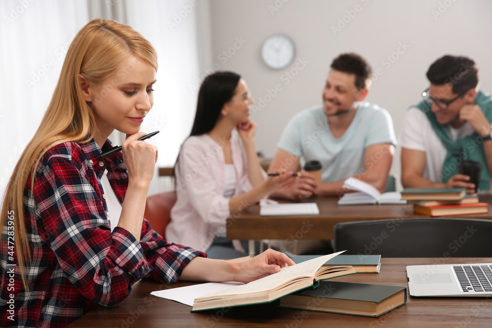 Students reading books and studying in library Students reading books and studying in library