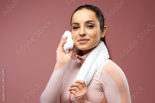 Konstfotografi Sporty young woman wiping face with towel