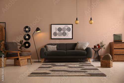 Stylish living room interior with comfortable dark sofa photo