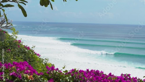 Video footage of beautiful view from the cliff to the blue ocean with lines of big waves for surfing in Bingin and Impossibles surf spot in Bali photo