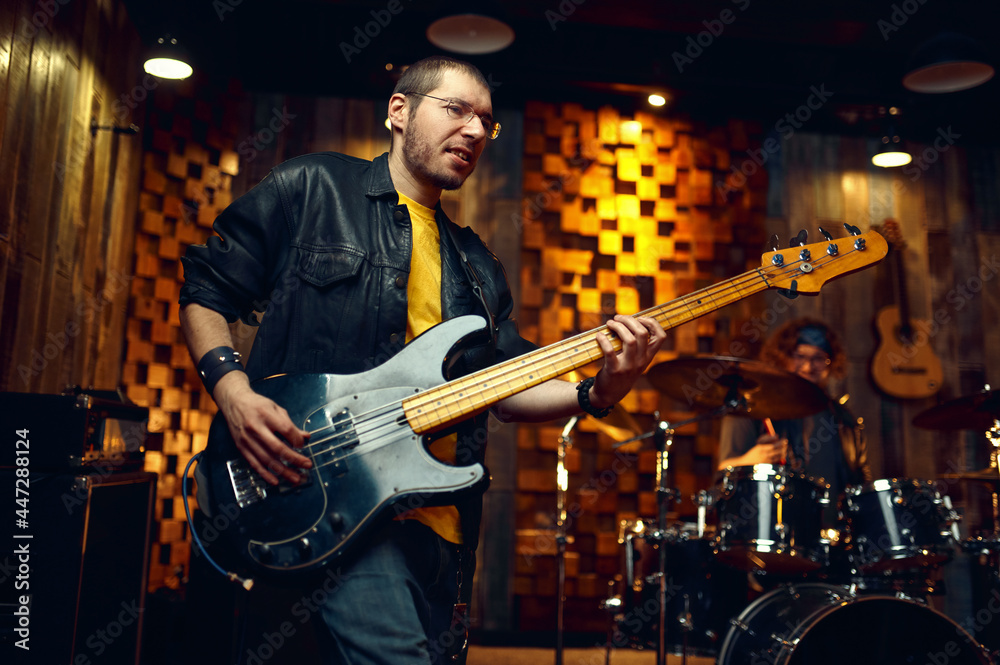 Fototapeta premium Brutal musician with electric guitar on stage