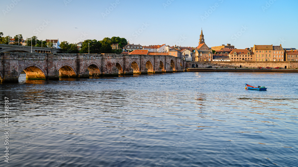Fototapeta premium Town Hall Spire beyond Berwick's Old Bridge. Berwick upon Tweed is the most northerly town in England and is located in Northumberland at the mouth of the River Tweed just below the Scottish border