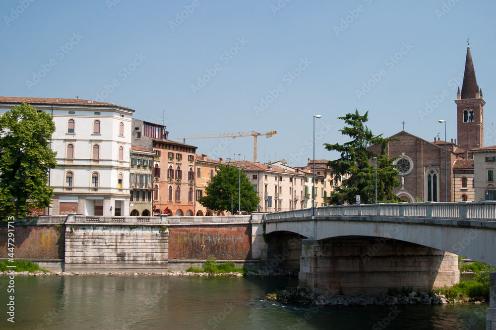 A typical Italian town in Tuscany with a bridge and river in the foreground