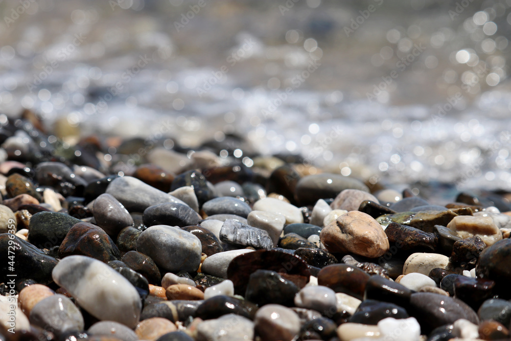 Pebble stones on blurred background of sea waves. Summer vacation concept Pebble stones on blurred background of sea waves. Summer vacation concept