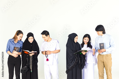 Group of multi religion in different traditional clothes include Christian, Islamic, Buddhism talking on white background. Variety of Religious Asian people knowledge exchange. Studio shot. photo