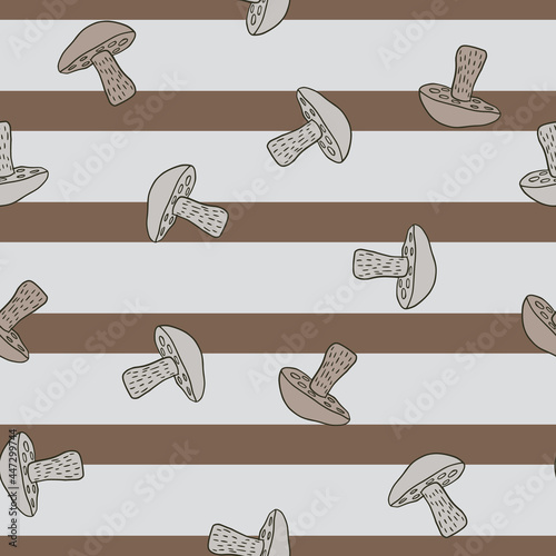 Decorative seamless pattern with random Leccinum scabrum mushroom ornament. Striped background.