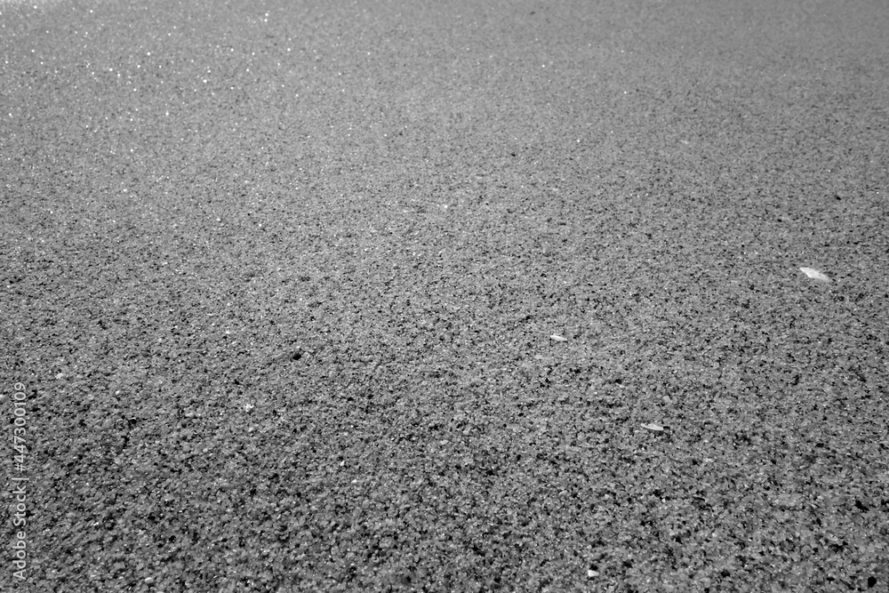 Beach sea sand close-up in black and white.