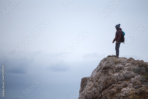silhouette of a man with a backpack on the mountain © zhukovvvlad