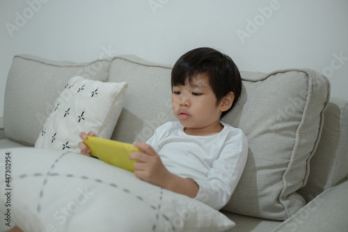 Asian little boy play smartphone