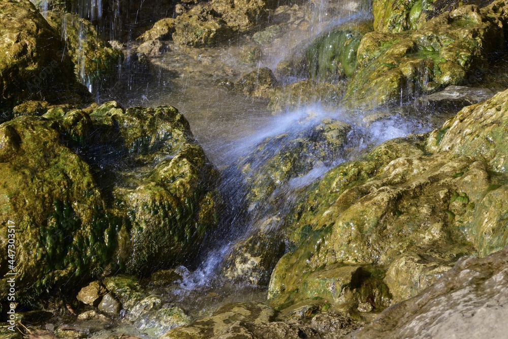 The stream water over the plaster rock of the Plakun waterfall