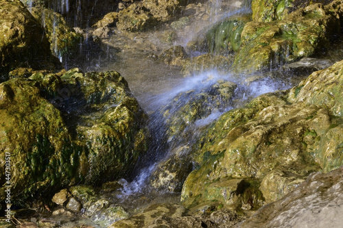 The stream water over the plaster rock of the Plakun waterfall